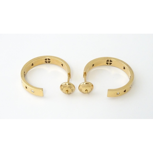 661 - A pair of gilt metal hoop earrings set with white stones by Folli Follie. Approx. 1