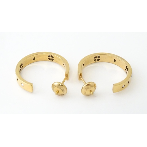 661 - A pair of gilt metal hoop earrings set with white stones by Folli Follie. Approx. 1