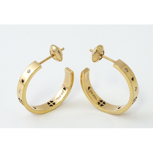 661 - A pair of gilt metal hoop earrings set with white stones by Folli Follie. Approx. 1