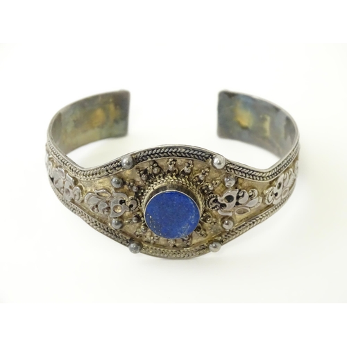 662 - A Continental white metal bracelet set with lapis lazuli. Probably Egyptian.