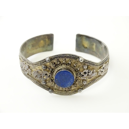 662 - A Continental white metal bracelet set with lapis lazuli. Probably Egyptian.