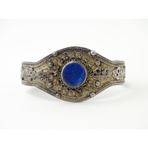 662 - A Continental white metal bracelet set with lapis lazuli. Probably Egyptian.