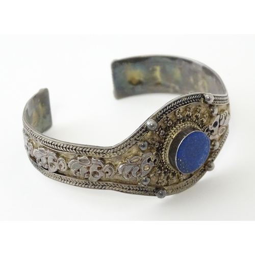 662 - A Continental white metal bracelet set with lapis lazuli. Probably Egyptian.