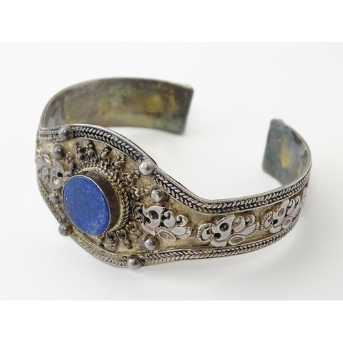 662 - A Continental white metal bracelet set with lapis lazuli. Probably Egyptian.