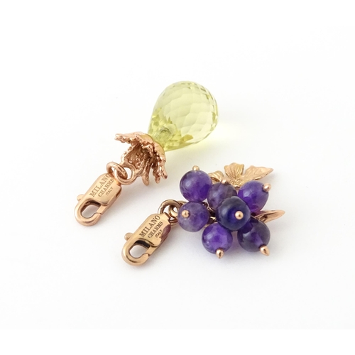 667 - Two Italian novelty silver gilt pendant charms modelled as fruit comprising amethyst grapes and lemo... 