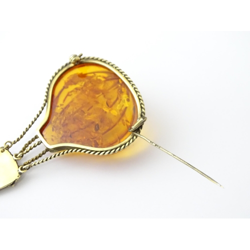 679 - A gilt metal brooch unusually formed as a hot air balloon, the balloon section with amber detail. Ap... 