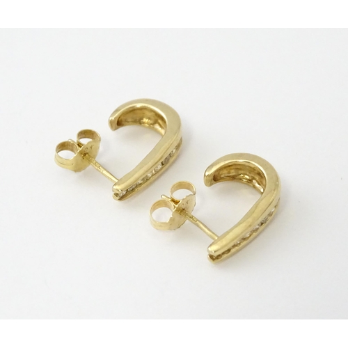 680 - A pair of 9ct gold earrings with channel set diamonds. Approx. 3/4