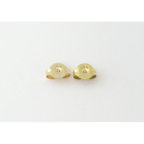 680 - A pair of 9ct gold earrings with channel set diamonds. Approx. 3/4