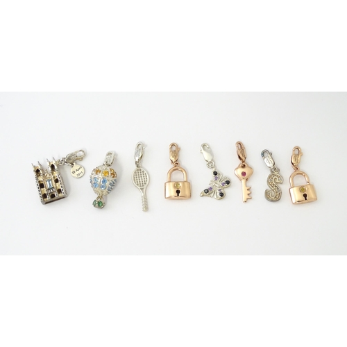 682 - Eight various silver and silver gilt charms to include Westminster Abbey, butterfly, tennis racket, ... 