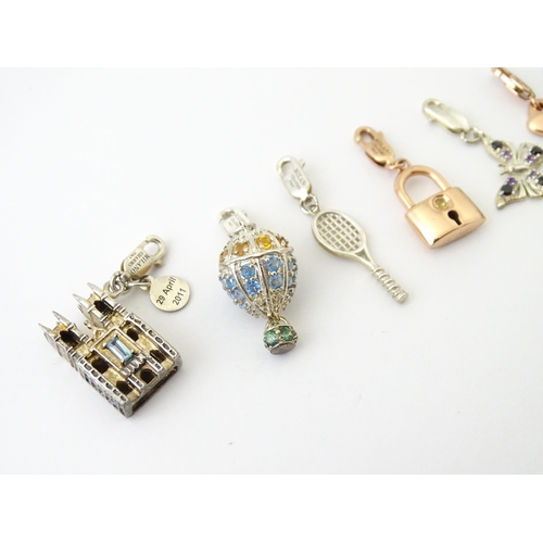 682 - Eight various silver and silver gilt charms to include Westminster Abbey, butterfly, tennis racket, ... 