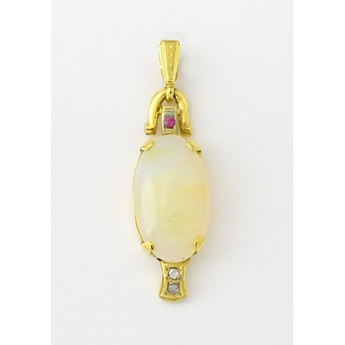 683 - A 14ct gold pendant set with central opal cabochon with diamonds and ruby in an Art Deco style setti... 