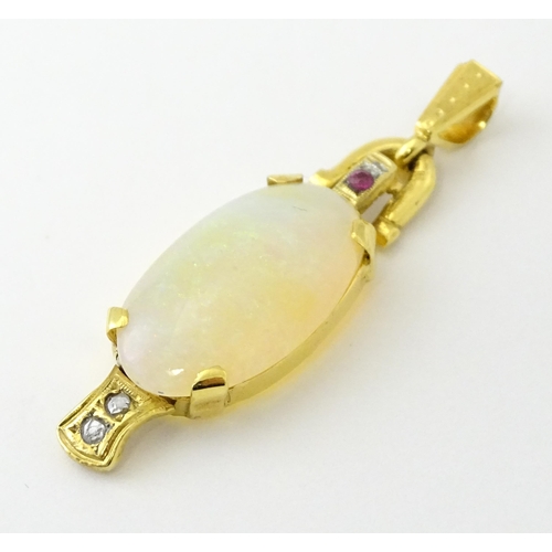 683 - A 14ct gold pendant set with central opal cabochon with diamonds and ruby in an Art Deco style setti... 