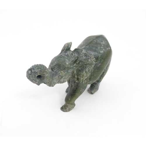 1225 - A quantity of 20thC carved models of animals to include elephant, dolphin, seal, rhinoceros, etc. To... 