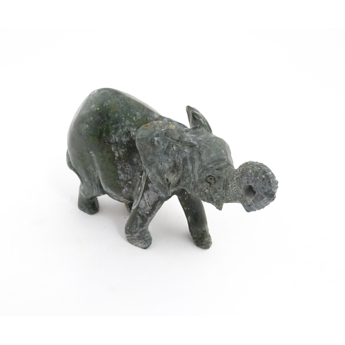 1225 - A quantity of 20thC carved models of animals to include elephant, dolphin, seal, rhinoceros, etc. To... 