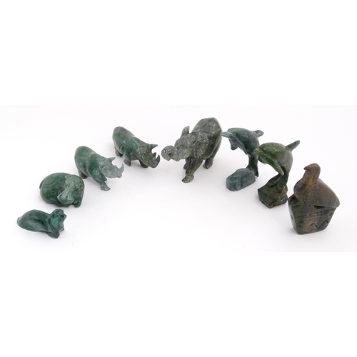 1225 - A quantity of 20thC carved models of animals to include elephant, dolphin, seal, rhinoceros, etc. To... 