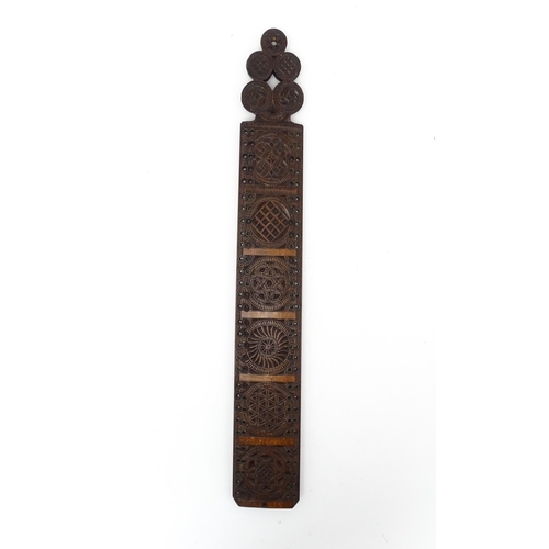 1229 - Treen : A 19thC beech Friesland mangle board with carved flower heads, roundels, etc. later converte... 