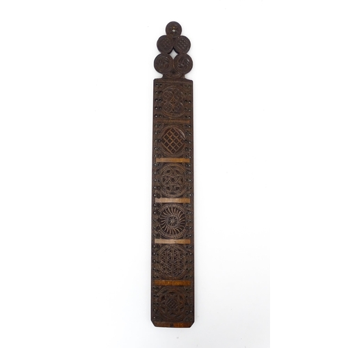 1229 - Treen : A 19thC beech Friesland mangle board with carved flower heads, roundels, etc. later converte... 