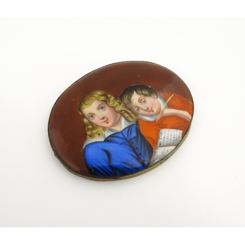 1233 - A 19thC porcelain plaque of oval form with hand painted detail depicting a young boy writing with a ... 