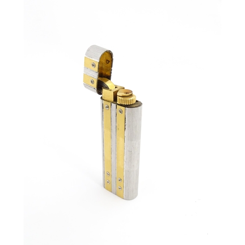 1250 - A pocket lighter by Cartier, Paris,with etched steel and gilt decoration and stamped to the base wit... 