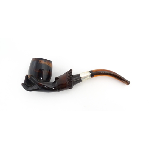 1253 - A Victorian meerschaum pipe carved as a hand with cuff holding the bowl, with amber mouthpiece and s... 