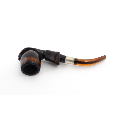 1253 - A Victorian meerschaum pipe carved as a hand with cuff holding the bowl, with amber mouthpiece and s... 