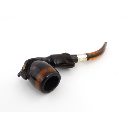 1253 - A Victorian meerschaum pipe carved as a hand with cuff holding the bowl, with amber mouthpiece and s... 