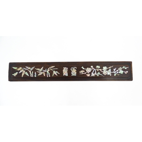 1267 - A Chinese hardwood scroll weight with inlaid abalone decoration depicting figures, bamboo and blosso... 