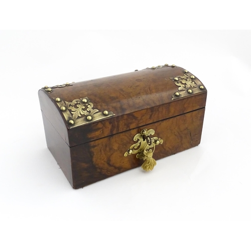 1269 - A 19thC walnut box, the dome top with applied brass mounts, opening to reveal a fitted interior and ... 