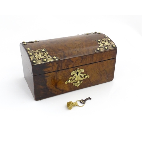 1269 - A 19thC walnut box, the dome top with applied brass mounts, opening to reveal a fitted interior and ... 