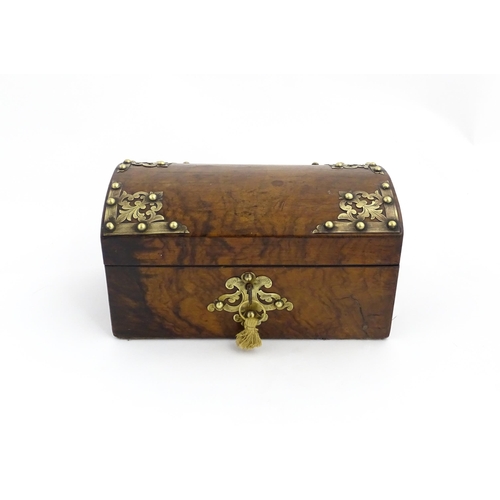 1269 - A 19thC walnut box, the dome top with applied brass mounts, opening to reveal a fitted interior and ... 