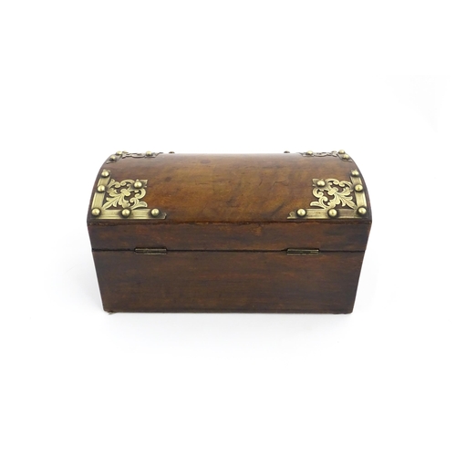 1269 - A 19thC walnut box, the dome top with applied brass mounts, opening to reveal a fitted interior and ... 