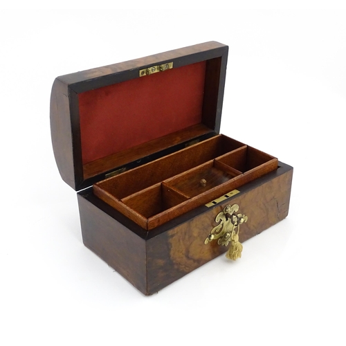 1269 - A 19thC walnut box, the dome top with applied brass mounts, opening to reveal a fitted interior and ... 