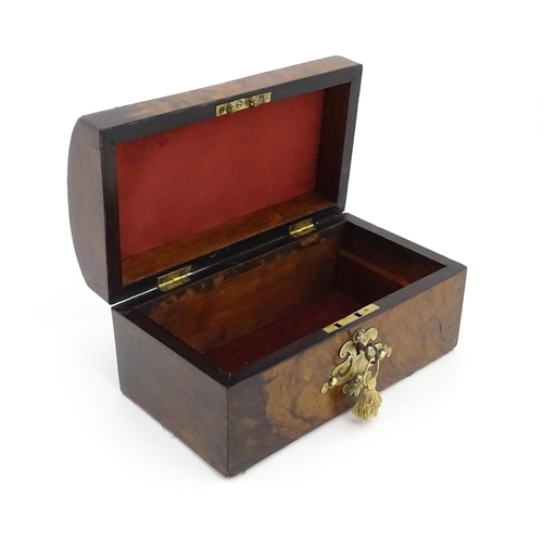 1269 - A 19thC walnut box, the dome top with applied brass mounts, opening to reveal a fitted interior and ... 