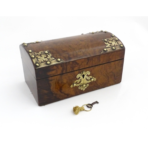 1269 - A 19thC walnut box, the dome top with applied brass mounts, opening to reveal a fitted interior and ... 