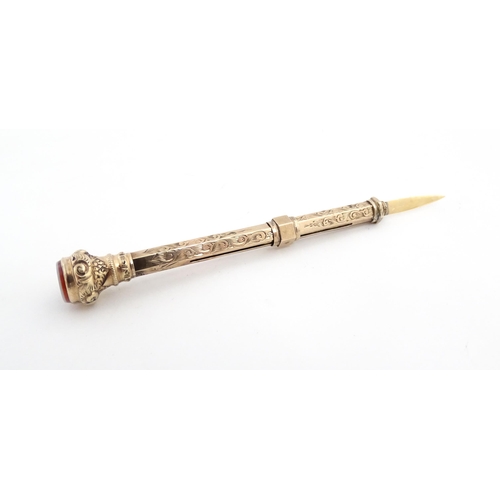 1276 - A Victorian gilt metal propelling toothpick with seal top. Approx. 2 3/4