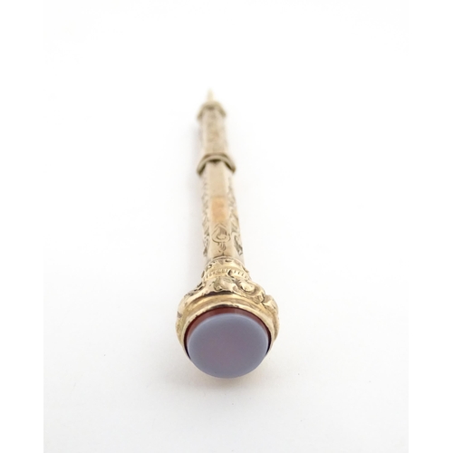 1276 - A Victorian gilt metal propelling toothpick with seal top. Approx. 2 3/4