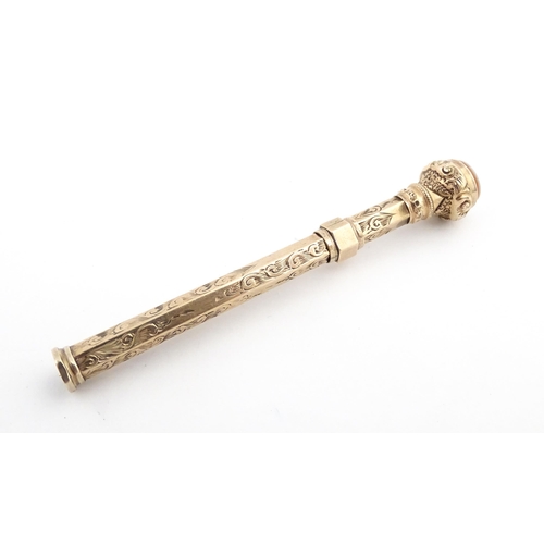 1276 - A Victorian gilt metal propelling toothpick with seal top. Approx. 2 3/4