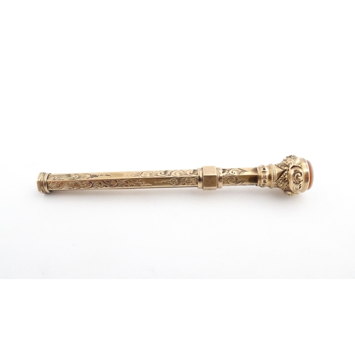 1276 - A Victorian gilt metal propelling toothpick with seal top. Approx. 2 3/4