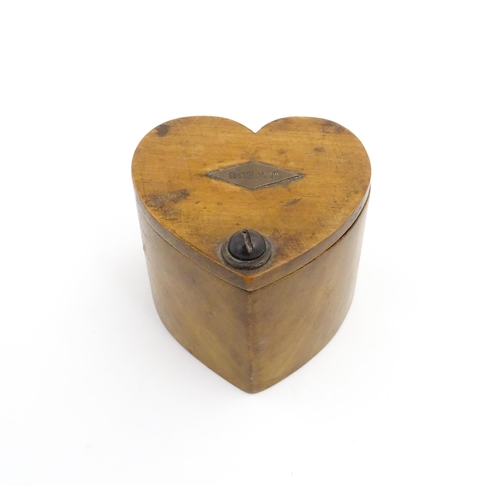 1280 - Treen : A late 19thC box of heart form with swivel lid, the top with applied lozenge engraved W. Web... 