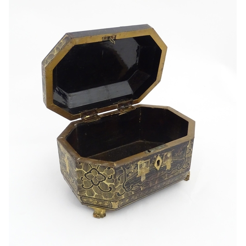 1281 - A 19thC lacquered casket of octagonal form raised on four paw feet, with chinoiserie decoration depi... 