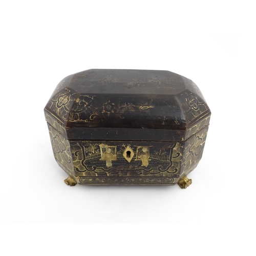 1281 - A 19thC lacquered casket of octagonal form raised on four paw feet, with chinoiserie decoration depi... 