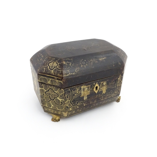 1281 - A 19thC lacquered casket of octagonal form raised on four paw feet, with chinoiserie decoration depi... 