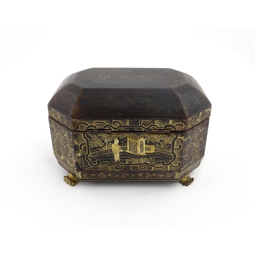 1281 - A 19thC lacquered casket of octagonal form raised on four paw feet, with chinoiserie decoration depi... 