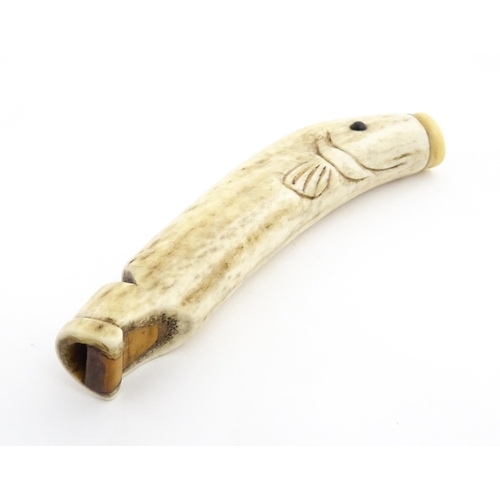 1282 - A 19thC novelty carved antler whistle of fish form. Approx. 5 1/4