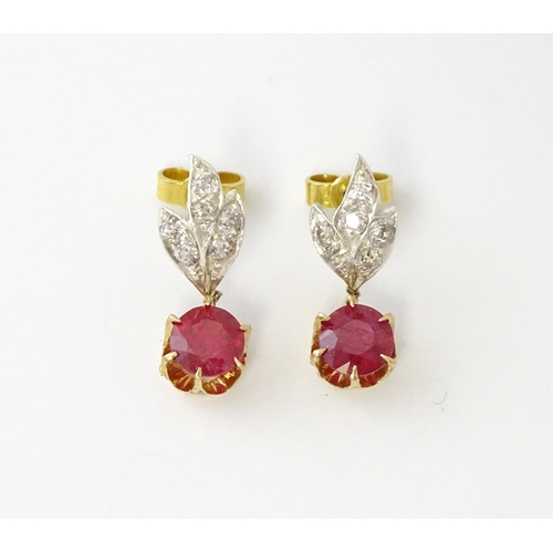 685 - A pair of drop earrings set with diamonds  and a ruby drop. Approx 3/4