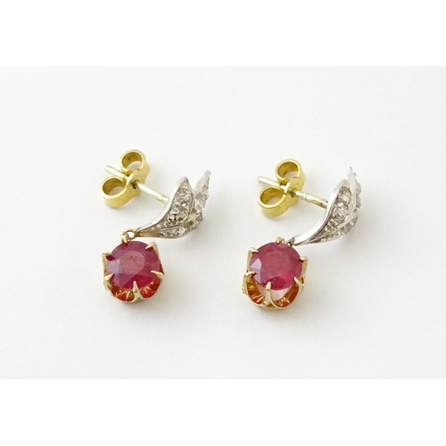 685 - A pair of drop earrings set with diamonds  and a ruby drop. Approx 3/4