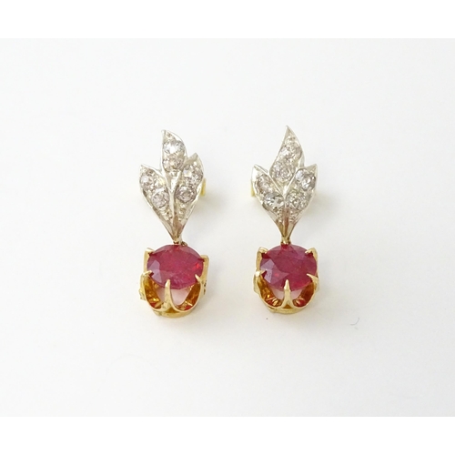 685 - A pair of drop earrings set with diamonds  and a ruby drop. Approx 3/4