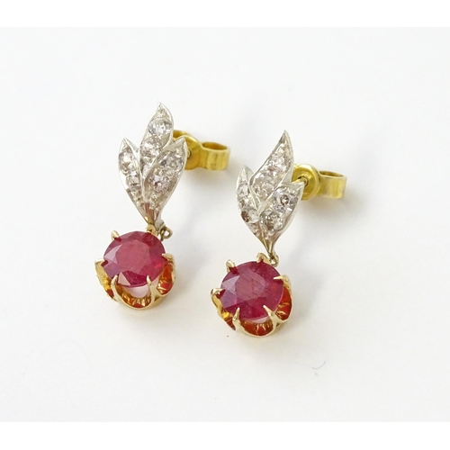 685 - A pair of drop earrings set with diamonds  and a ruby drop. Approx 3/4