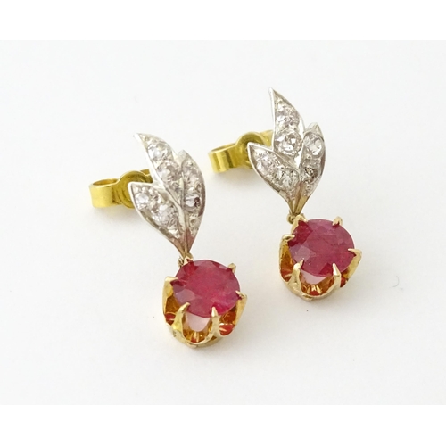 685 - A pair of drop earrings set with diamonds  and a ruby drop. Approx 3/4