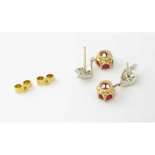 685 - A pair of drop earrings set with diamonds  and a ruby drop. Approx 3/4